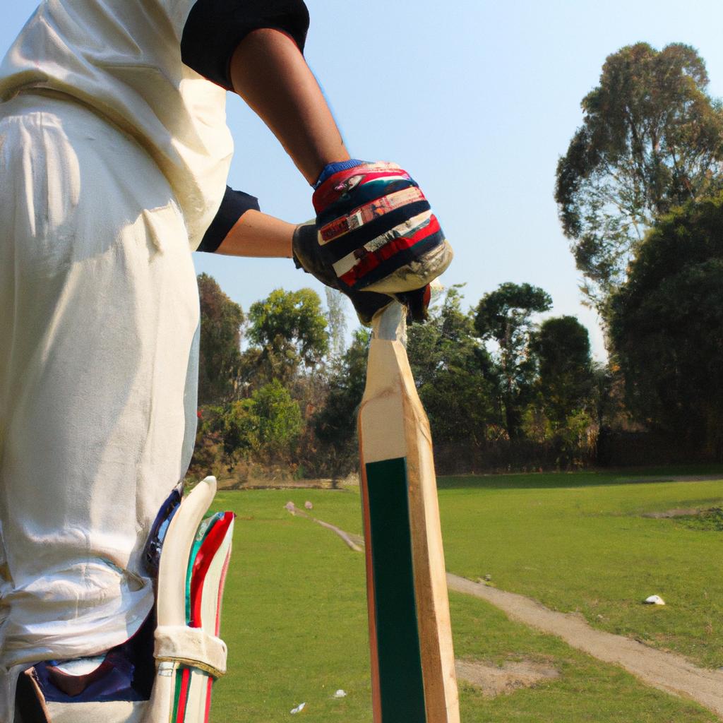 Person wearing cricket gear, batting