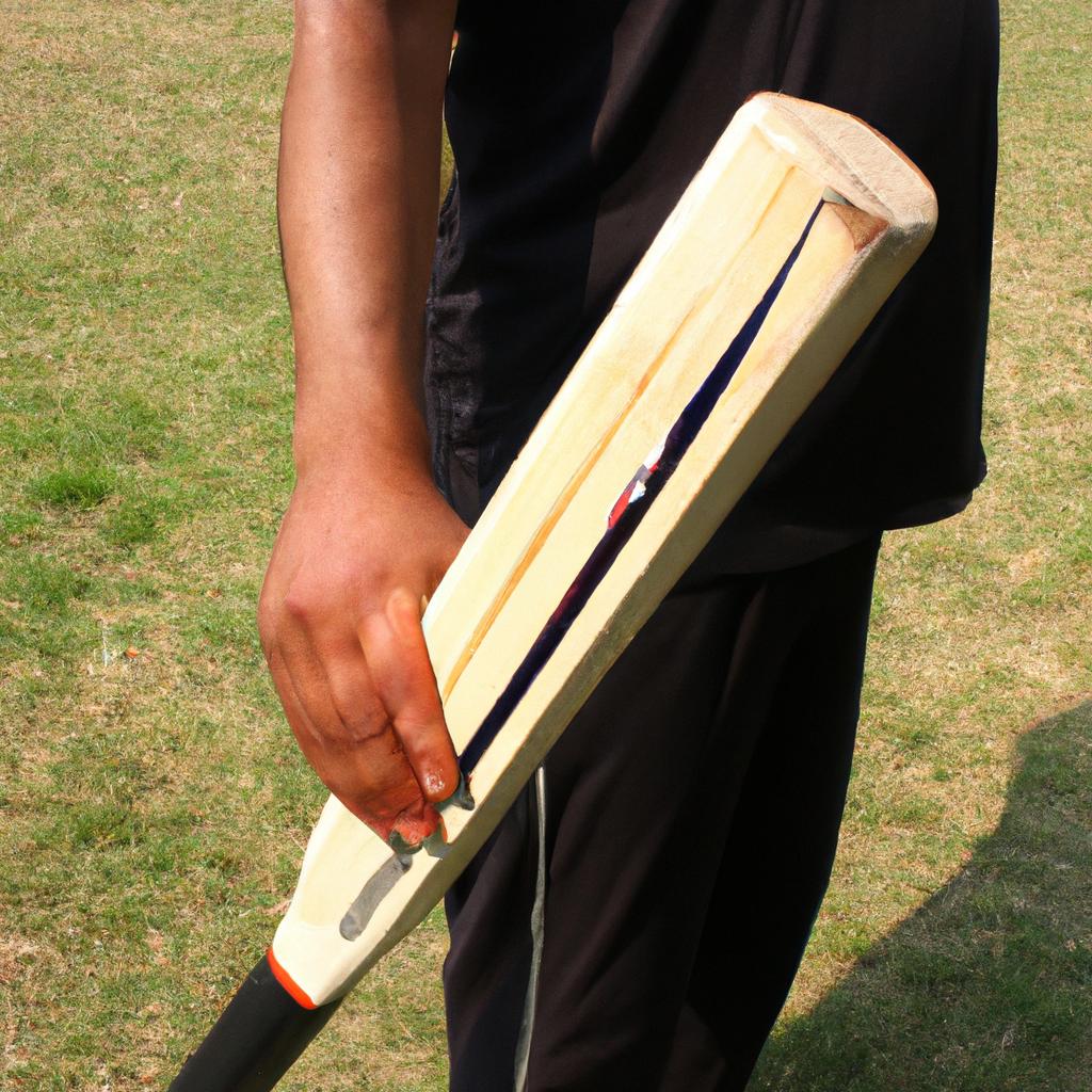 Person holding cricket bat, practicing