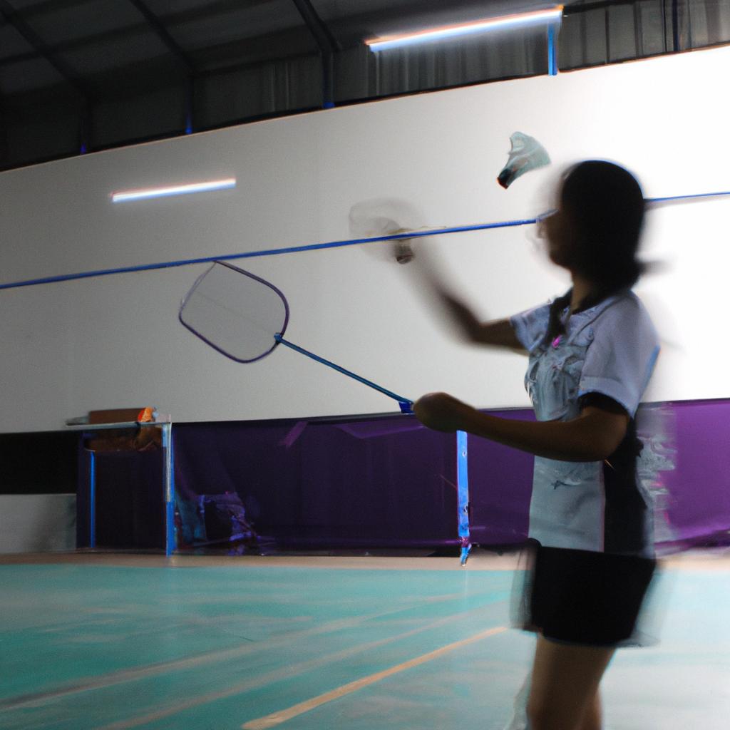 Person playing badminton in gym